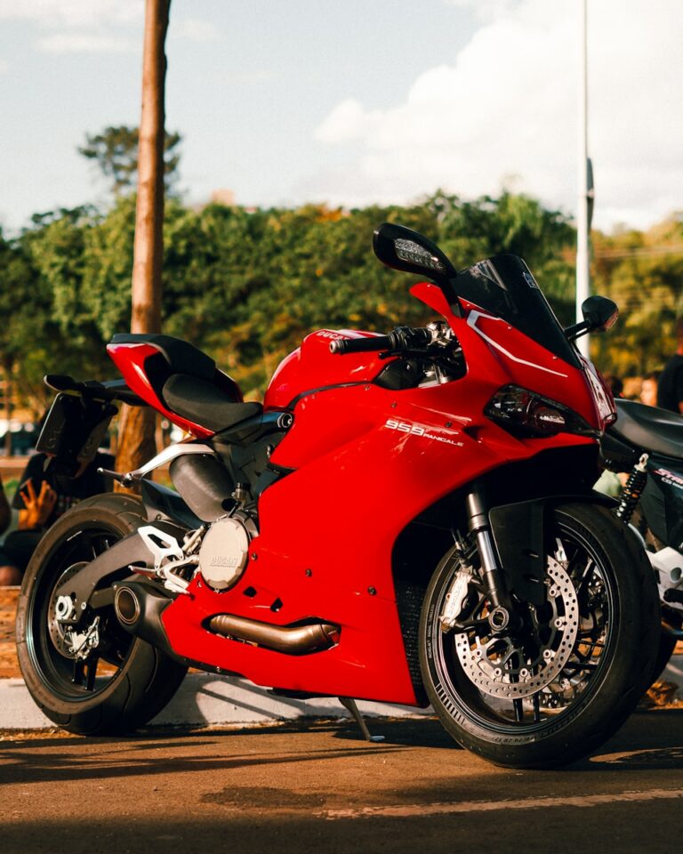 A red motorcycle parked on the side of the road